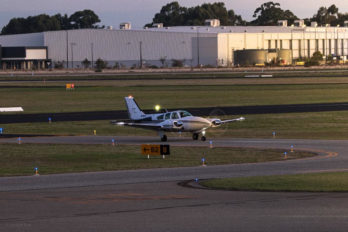 A twin-engine aircraft taxiing at dusk, before editing